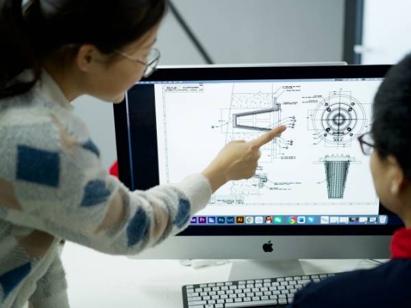 Designers are studying design according to blueprint.