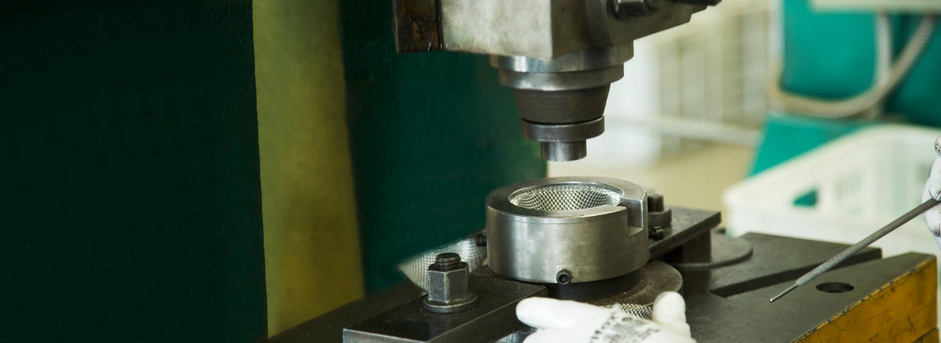 The stamping machine is stamping the fabricated parts.