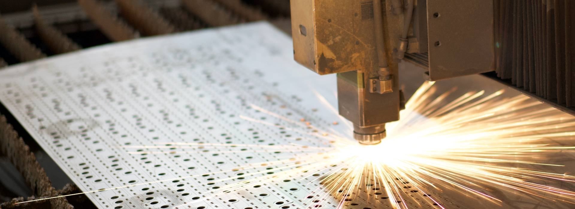 The laser cutting machine is cutting the metal plate into strips.