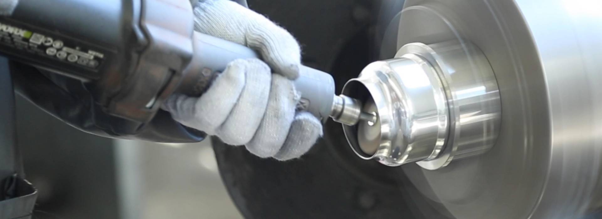 The machine is polishing the surface of filter elements.