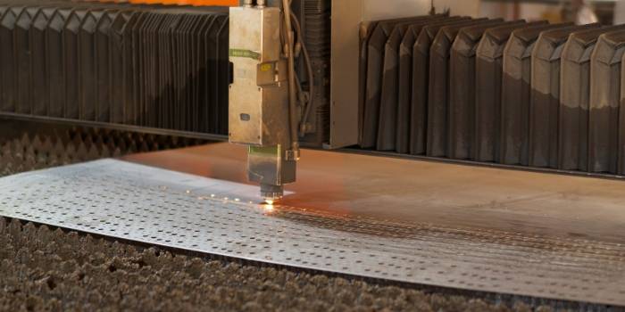 The focused laser beam is used to cut the metal plate.