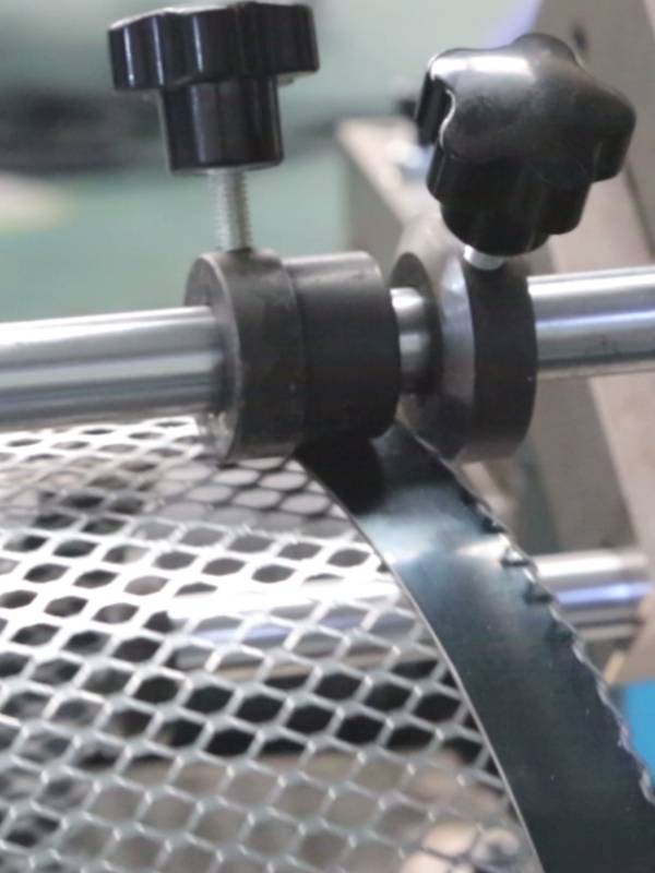 The machine is rolling the edge of the filter element.